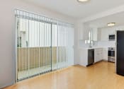 Thumbnail 10 of 12 - Balcony sliding glass door next to open kitchen adjacent to dining room