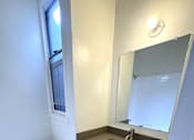 Thumbnail 21 of 23 - A white toilet sits next to a sink in a bathroom.