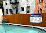 Thumbnail 3 of 21 - A pool with a warning sign on the wall.
