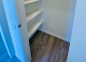 Thumbnail 12 of 21 - a walk in closet with shelves and a door