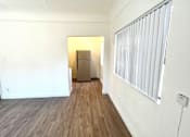 Thumbnail 16 of 23 - Refrigerator view from the living space, windows with white blind slats