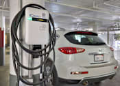Thumbnail 31 of 34 - A white car is plugged into an E-Drive charger. at Westwood Riviera Apartments, Los Angeles, California