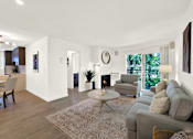 Thumbnail 29 of 34 - A living room with a grey couch and a coffee table at Westwood Riviera Apartments, Apartments, Los Angeles, CA