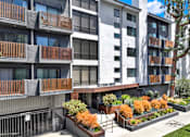 Thumbnail 5 of 34 - A modern apartment building with a well-maintained outdoor area. at Westwood Riviera Apartments, California