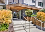 Thumbnail 13 of 34 - A building with a wooden entrance and steps leading up to it at Westwood Riviera Apartments, California, 90024