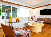 Thumbnail 11 of 18 - a living room with a couch and a table at 8535 Colgate-Fully Furnished Apartments, Los Angeles, CA