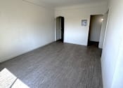 Thumbnail 7 of 23 - A room with a grey carpet and a white wall.