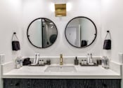 Thumbnail 9 of 18 - two mirrors above a bathroom sink in a hotel room at 8535 Colgate-Fully Furnished Apartments, Los Angeles