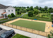Thumbnail 5 of 18 - A black car is parked in a driveway next to a house. at Merion at Cross Keys Apartments, Williamstown, NJ, 08094