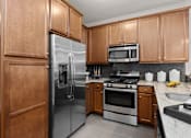 Thumbnail 6 of 18 - A kitchen with a refrigerator, oven, microwave, and sink. at Merion at Cross Keys Apartments, Williamstown