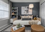 Thumbnail 14 of 21 - A cozy living room with a white sofa and a large abstract painting on the wall.