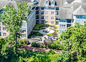 Thumbnail 27 of 31 - A large building with a courtyard surrounded by trees. at Merion Riverwalk Apartment Homes, Connecticut, 06484