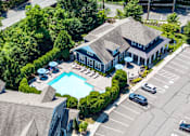 Thumbnail 12 of 19 - A large building with a pool in front of it.
