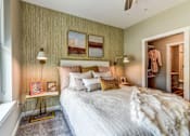 Thumbnail 6 of 20 - A bedroom with a large bed and a window.