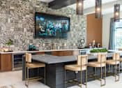 Thumbnail 7 of 20 - A modern kitchen with a large central island and a patterned backsplash.