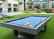 Thumbnail 17 of 20 - A pool table with balls and cues on it.