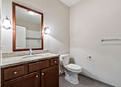 Thumbnail 11 of 16 - A bathroom with a toilet, sink, and mirror. at Pennsauken Golf Course Villas, PENNSAUKEN