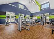 Thumbnail 7 of 19 - A gym with a variety of equipment and a wooden floor.