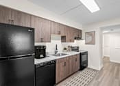 Thumbnail 1 of 8 - A kitchen with a black fridge, black dishwasher, and black oven.