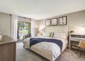 Thumbnail 10 of 32 - Bedroom with bed and lamp at The Fountains at Deerwood Apartments, Jacksonville