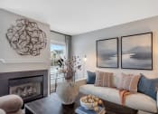 Thumbnail 5 of 35 - a living room with a white couch and a fireplace at The Austin Apartment Homes, Deptford