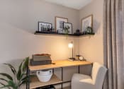 Thumbnail 21 of 35 - a desk with a chair and a plant in a room at The Austin Apartment Homes, Deptford, 08096
