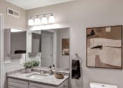 Thumbnail 23 of 35 - a bathroom with a sink and mirrors and a mirror on the wall at The Austin Apartment Homes, New Jersey