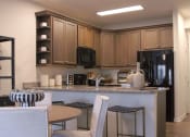 Thumbnail 13 of 36 - a view of a kitchen and a living room with a table and chairs  at Carillon Woods, Delaware