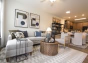 Thumbnail 16 of 36 - a living room with a couch and a table  at Carillon Woods, Millsboro