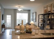 Thumbnail 15 of 36 - the view of the living room from the kitchen counter in a model home  at Carillon Woods, Millsboro, Delaware