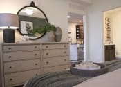 Thumbnail 24 of 36 - a bedroom with a dresser and a bed with a mirror on it  at Carillon Woods, Millsboro, DE, 19966