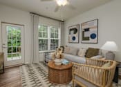 Thumbnail 9 of 31 - A living room with a couch, a coffee table, and a ceiling fan.