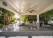 Thumbnail 16 of 20 - a large entertaining area with a bar and a kitchen at Champions Walk Apartment Homes, Bradenton, Florida