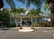 Thumbnail 19 of 20 - a large white building with palm trees in front of it at Champions Walk Apartment Homes, Bradenton, Florida