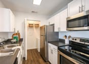 Thumbnail 5 of 20 - Chef-Inspired Kitchens Feature Stainless Steel Appliances at Champions Walk Apartment Homes, Bradenton, FL