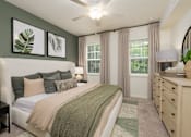 Thumbnail 11 of 31 - A bedroom with a bed, nightstand, and a ceiling fan.