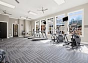 Thumbnail 23 of 28 - A gym with treadmills and exercise machines.