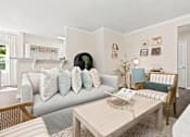 Thumbnail 2 of 28 - A living room with a grey couch and a coffee table.