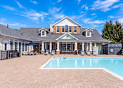 Thumbnail 14 of 28 - A large house with a pool in the backyard.