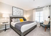 Thumbnail 4 of 24 - a bedroom with a bed and a window at Merion Milford Apartment Homes, Milford, CT 06460