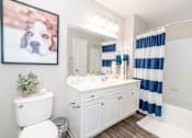 Thumbnail 20 of 24 - a white bathroom with a picture of a dog at Merion Milford Apartment Homes, Milford, 06460