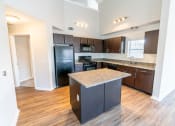 Thumbnail 12 of 26 - a kitchen with black appliances and granite counter tops at Merion Riverwalk Apartment Homes, Shelton, 06484
