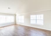 Thumbnail 15 of 26 - a living room with a hard wood floor and two windows at Merion Riverwalk Apartment Homes, Shelton, CT, 06484