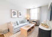 Thumbnail 2 of 26 - a living room with a couch and a coffee table at Merion Riverwalk Apartment Homes, Shelton, 06484