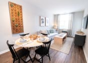 Thumbnail 1 of 26 - a living room with a table and a couch at Merion Riverwalk Apartment Homes, Shelton, 06484
