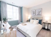 Thumbnail 6 of 26 - a bedroom with a bed and two windows at Merion Riverwalk Apartment Homes, Shelton, 06484