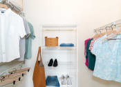 Thumbnail 9 of 26 - a closet filled with clothes and shoes and a bag at Merion Riverwalk Apartment Homes, Shelton, 06484