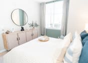 Thumbnail 8 of 26 - a bedroom with a bed and a mirror at Merion Riverwalk Apartment Homes, Shelton, 06484