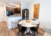 Thumbnail 4 of 26 - a dining room and kitchen with a table and chairs at Merion Riverwalk Apartment Homes, Shelton, 06484