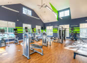 Thumbnail 5 of 27 - a gym with weights and cardio equipment and windows at Merion Stratford Apartment Homes, Stratford, CT, 06614